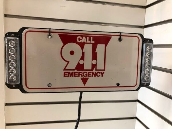 Call 911 Emergency sign with lights.