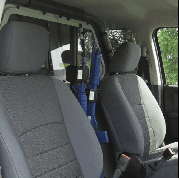 The back seat of a vehicle with the TRI-LOCK VERTICAL PARTITION MOUNT in it.